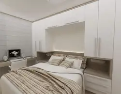 Bed between wardrobes in bedroom design