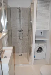 Bathroom With Tiled Shower And Washing Machine Photo