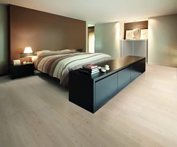 What kind of floors are in the bedroom photo