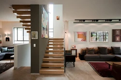 Living room design with stairs to the second floor photo