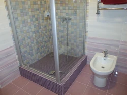 Photo of a bathroom with a tray instead of a bathtub