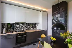 Photo Of A Kitchen With A Black Panel