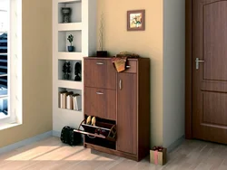 Shoe rack and mirror in the hallway in the interior