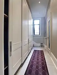 Photo of a hallway with a wardrobe in a modern style, narrow and long