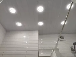 Bathroom ceiling made of plastic panels with spotlights photo