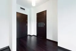 Dark Doors, Light Floor In The Interior Of The Apartment