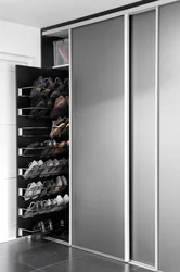 Sliding wardrobes in the hallway with a mirror and shoe rack design