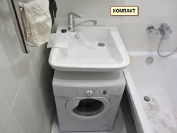 Photo of a washing machine under the sink in the bathroom