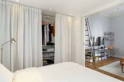 Dressing room with curtains instead of doors in the bedroom photo