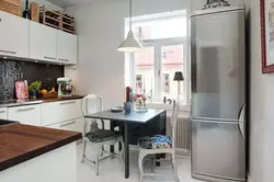 Design Of A Small Kitchen With A Refrigerator By The Window