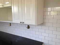 Photo of white tiles with black grout in the bathroom