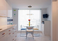 Table by the window in a small kitchen with your own photos