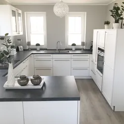 Gray kitchen with dark countertops in the interior photo