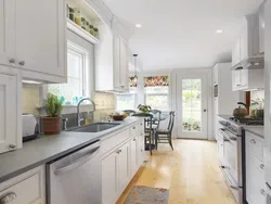 Design of a narrow kitchen with a window on the entire wall