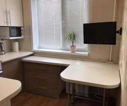 Kitchen design in Khrushchev with a window sill and countertop