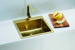 Golden sink in the kitchen interior