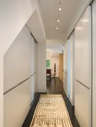 Design of a long hallway in an apartment photo with a wardrobe