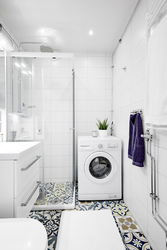 Photo of a bathroom with shower and washing machine photo