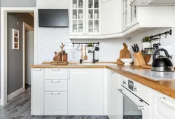 White set with a wooden countertop in the kitchen interior