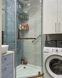 Bathroom interior with shower and washing machine