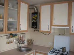 Photo of a small kitchen with a window and a column