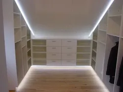 Dressing room in the attic with a sloping ceiling photo