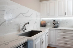 Kitchen with marble countertop and splashback photo