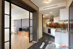 Living room with door to kitchen design