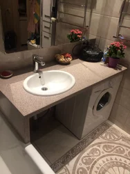 Washbasin on the countertop in the bath photo
