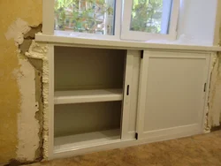 Cabinet in the window sill in the kitchen photo