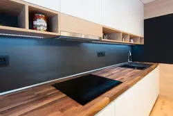 Photo of a kitchen with an apron and a wood-look countertop