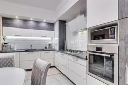 Interior of a corner kitchen in a modern style in light colors