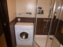 Bathroom in Khrushchev with a shower and washing machine photo