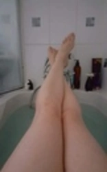 Photo of women's legs in the bathroom