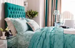 Turquoise bed in a bedroom interior with soft