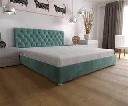 Turquoise bed in a bedroom interior with soft