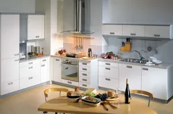 Photo of white kitchen and household