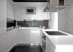 Kitchen with a gray countertop in a white interior and an apron