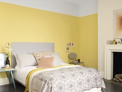 Yellow wall color in the bedroom interior