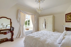 White curtains in the bedroom interior