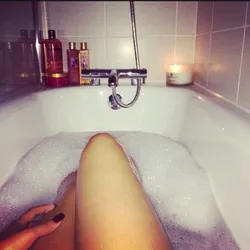 Photo of feet in bathtub with foam