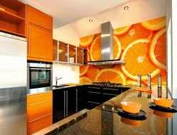 Orange-black kitchen in the interior photo