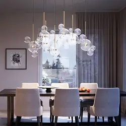 Modern chandeliers in the kitchen above the table photo