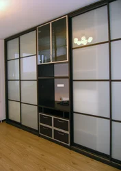 Built-in wardrobe in the living room on the entire wall photo