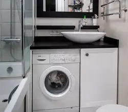 Washing machine under the sink in the bathroom design