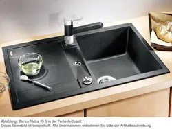 Kitchen sinks built into countertops made of artificial photo