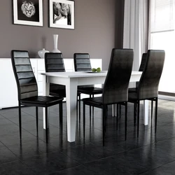 White table with black chairs in the kitchen interior