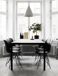 White table with black chairs in the kitchen interior