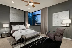 Bedroom interior with gray wallpaper and brown furniture