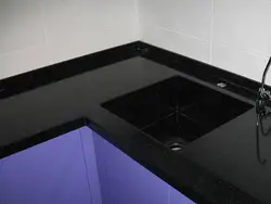 Black glossy countertop in the kitchen photo